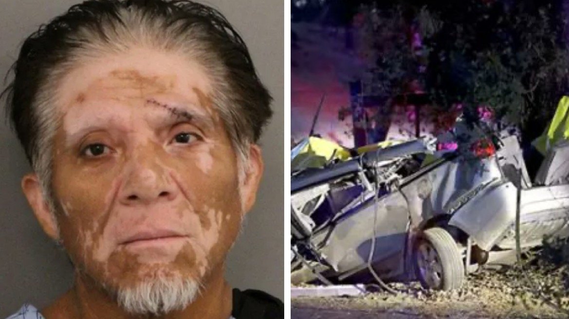 Man with facial scars and a serious expression next to a wrecked car at an accident scene, highlighting the aftermath of a vehicle collision.