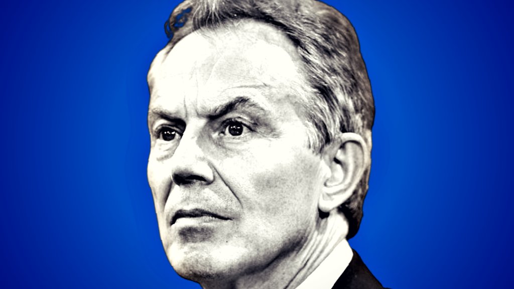 Portrait of a serious man against a blue background, showcasing intense expression and thoughtful demeanor.